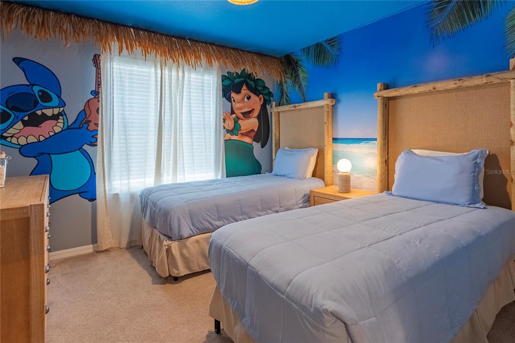 4425 Kaipo Road Davenport, FL 33897 - Photo 82 of 100 a bedroom with 2 bed and a window