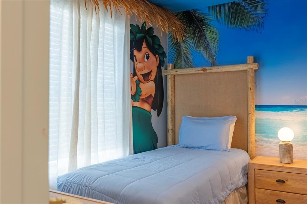 4425 Kaipo Road Davenport, FL 33897 - Photo 85 of 100 a bedroom with a bed and a potted plant