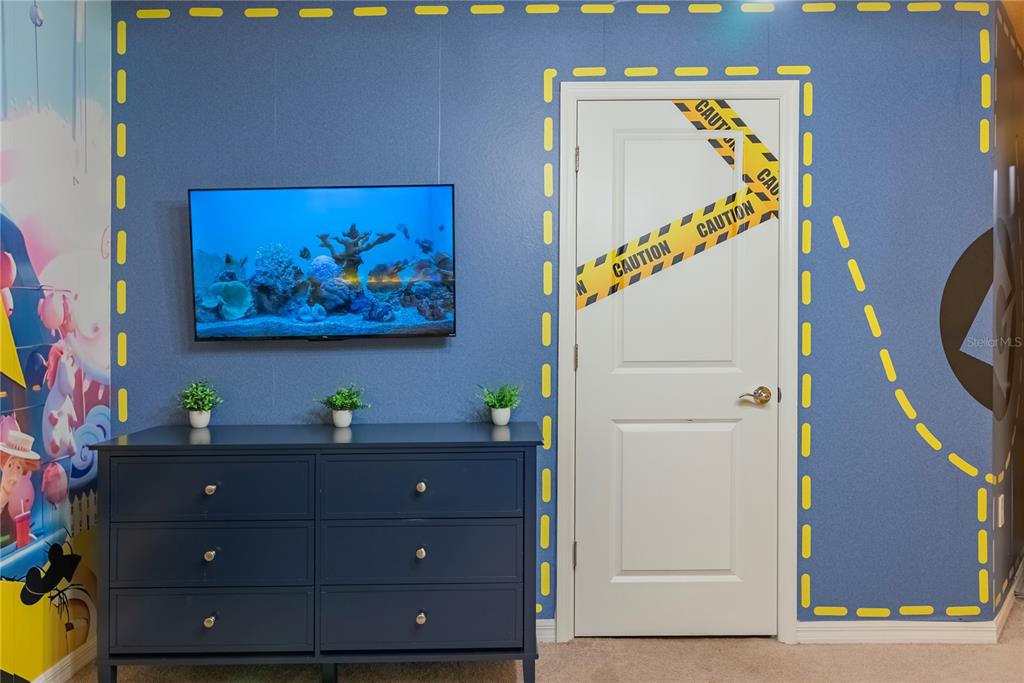 4425 Kaipo Road Davenport, FL 33897 - Photo 89 of 100 a view of a entryway with a flower pot and a bookshelf