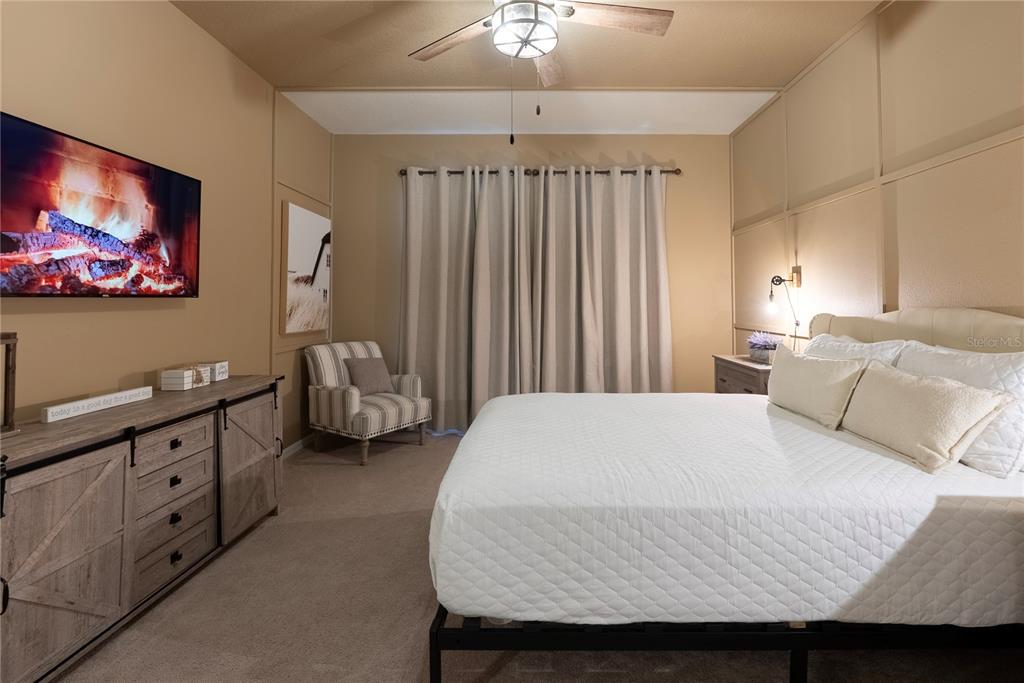 4425 Kaipo Road Davenport, FL 33897 - Photo 9 of 100 a bedroom with a bed and a flat screen tv