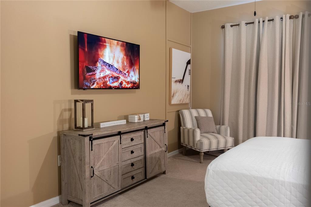 4425 Kaipo Road Davenport, FL 33897 - Photo 10 of 100 a bedroom with furniture and a wooden floor