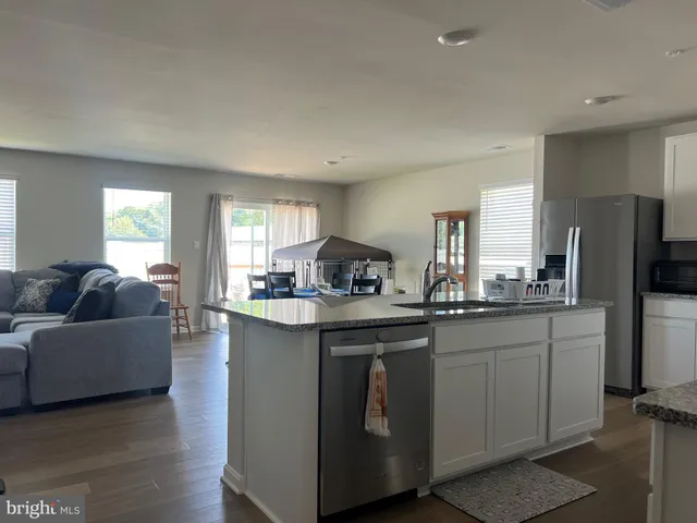 a kitchen with a sink stove and refrigerator
