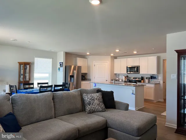 a living room with furniture and kitchen view