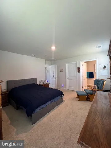 a living room with a couch and dresser