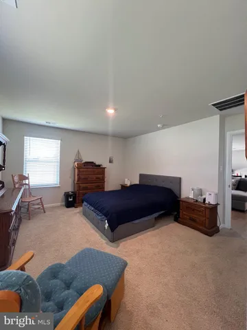 a spacious bedroom with a bed and window