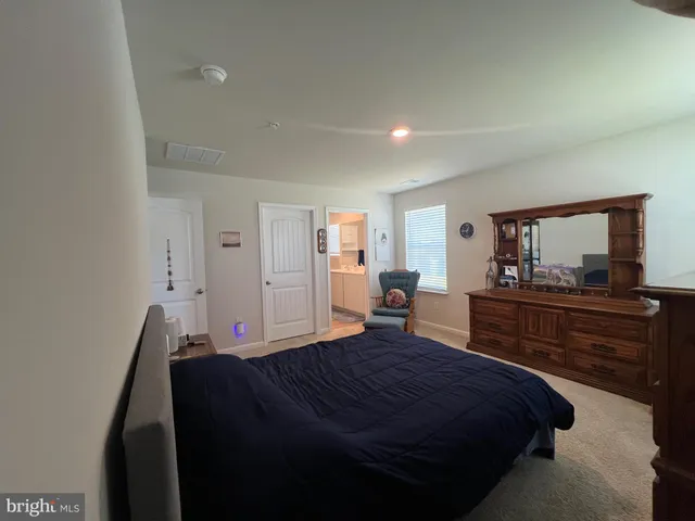 a bedroom with a bed and a dresser in it