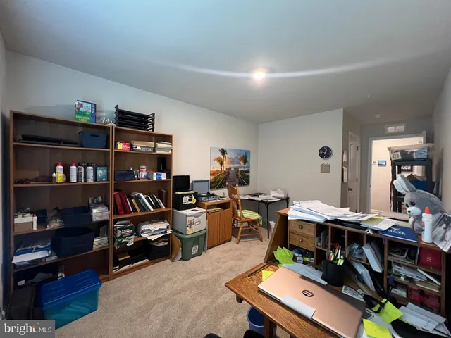 a room with furniture a bookshelf and a window