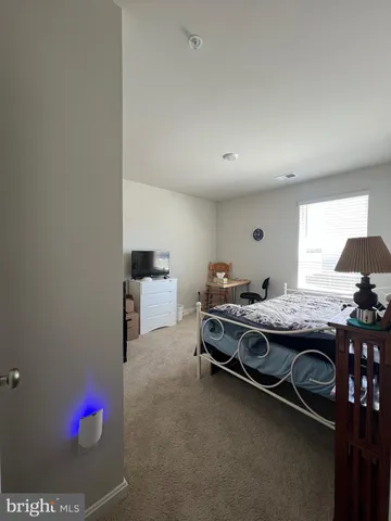 a bedroom with furniture and a chair