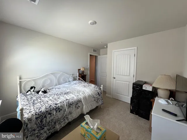 a bedroom with bed and window