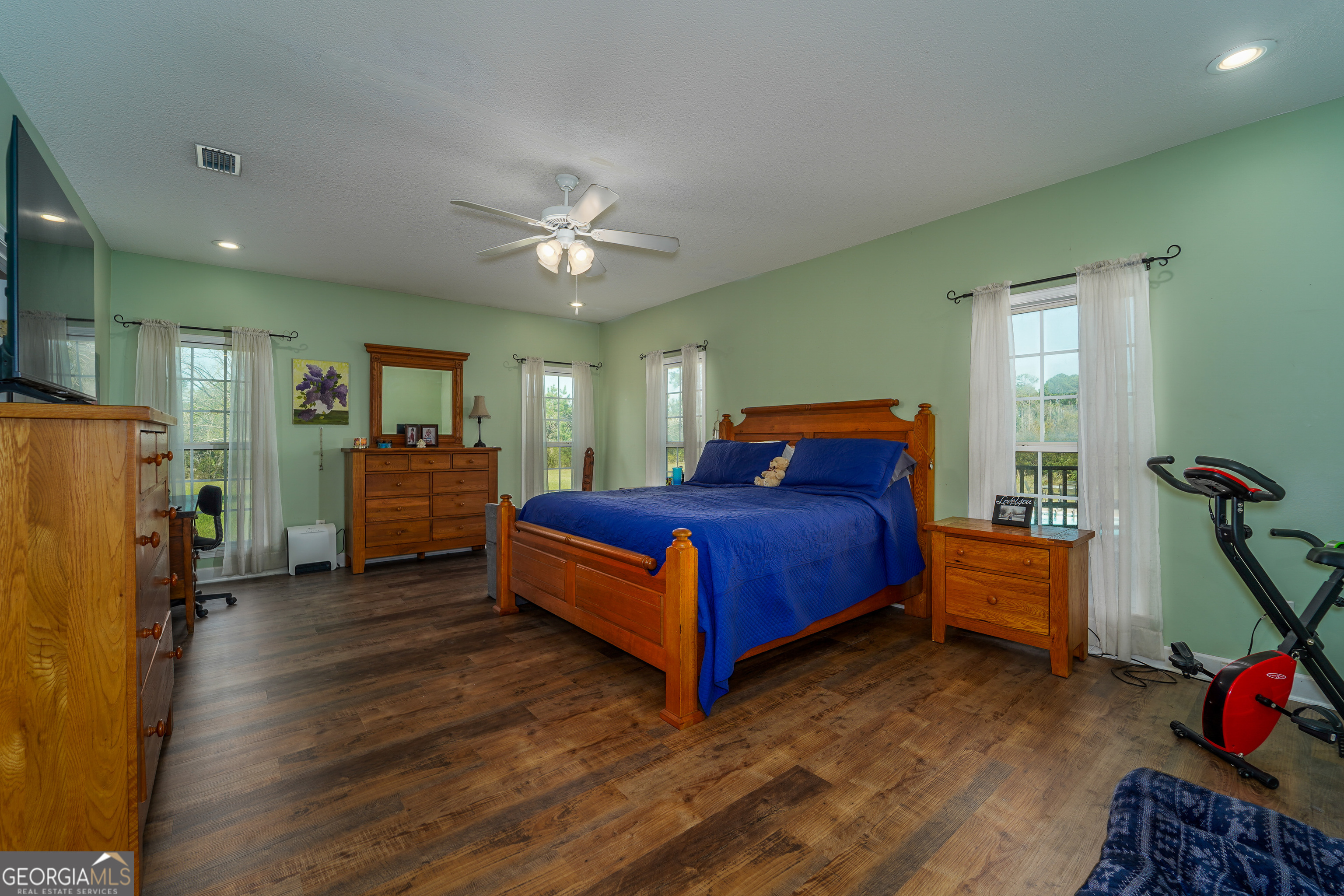 3300 Connor Lane Waycross, GA 31503 - Photo 28 of 42 a bedroom with a bed and a chandelier