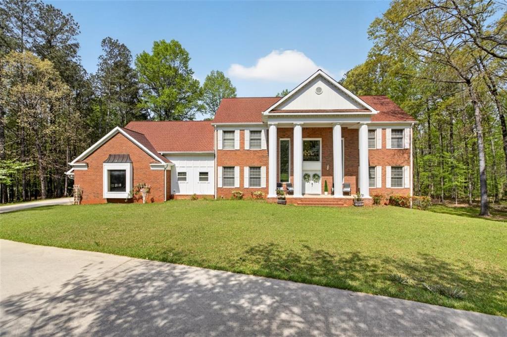 a front view of a house with a yard and porch