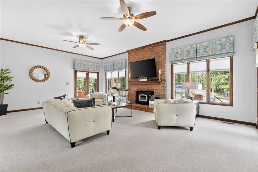 3035 Mt Zion Road Oxford, GA 30054 - Photo 30 of 99 a living room with furniture a fireplace and a flat screen tv
