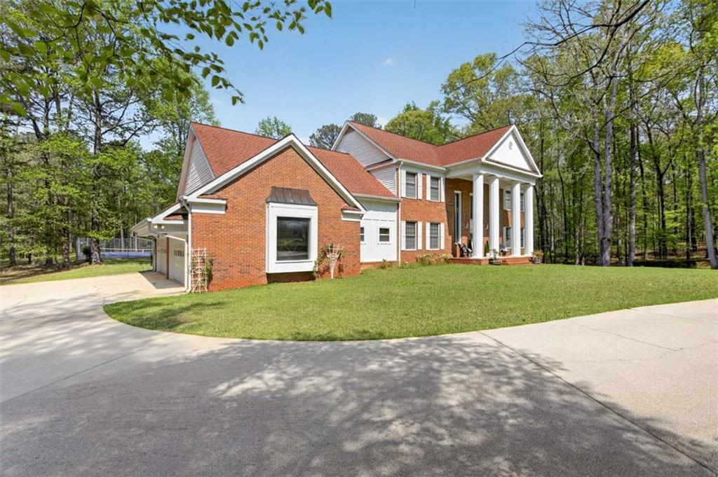 3035 Mt Zion Road Oxford, GA 30054 - Photo 3 of 99 a front view of a house with a yard and garage