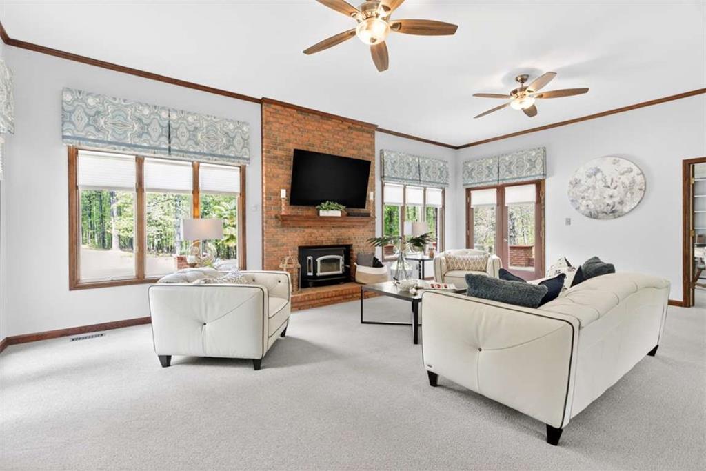 3035 Mt Zion Road Oxford, GA 30054 - Photo 33 of 99 a living room with furniture a fireplace and a flat screen tv