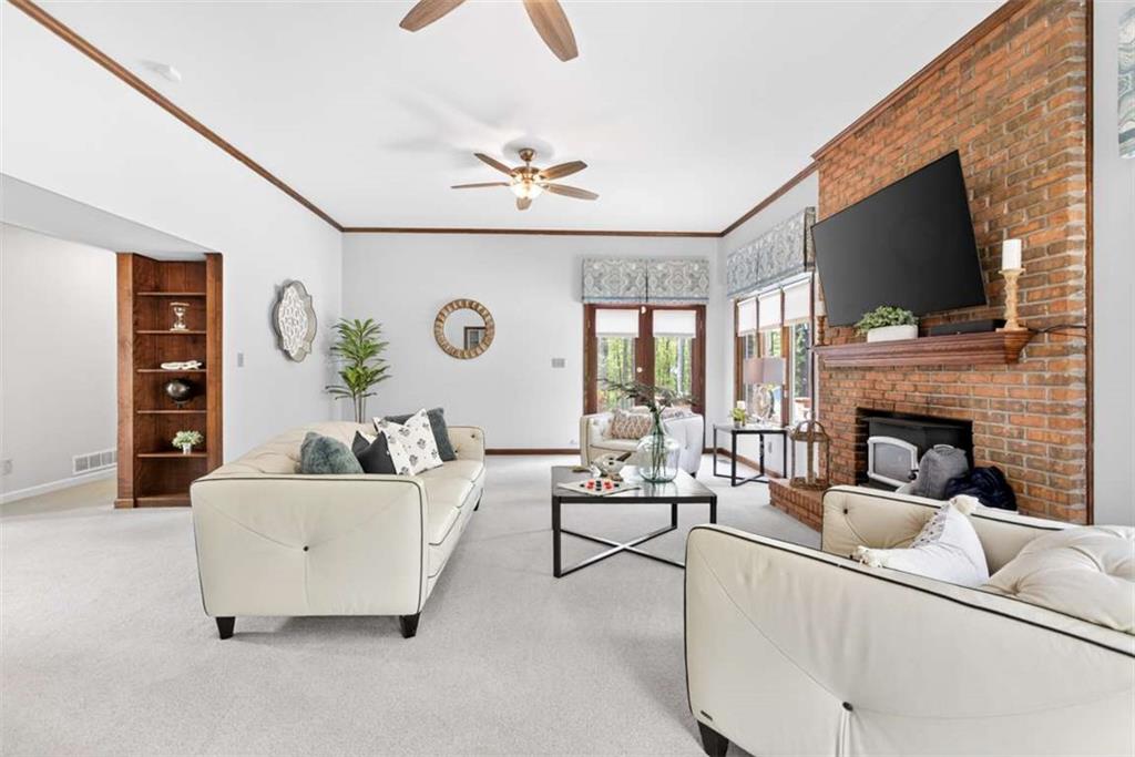 3035 Mt Zion Road Oxford, GA 30054 - Photo 34 of 99 a living room with furniture a flat screen tv and a fireplace