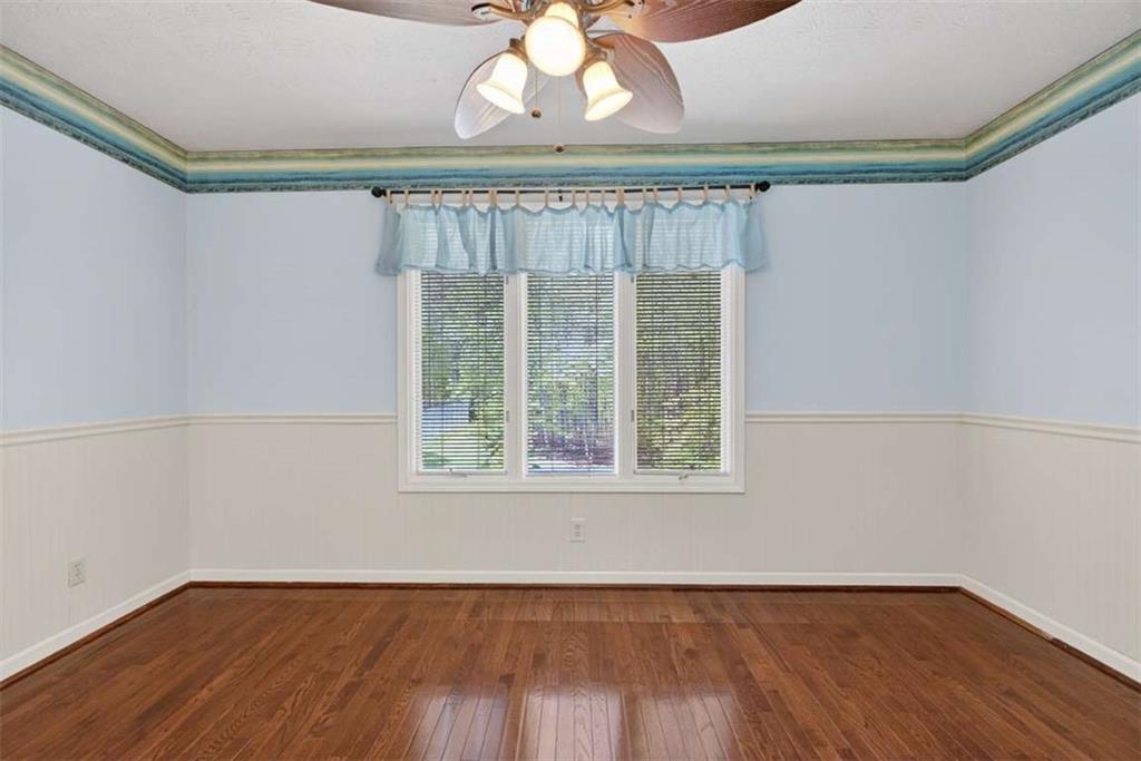 3035 Mt Zion Road Oxford, GA 30054 - Photo 46 of 99 a view of an empty room with wooden floor and a window
