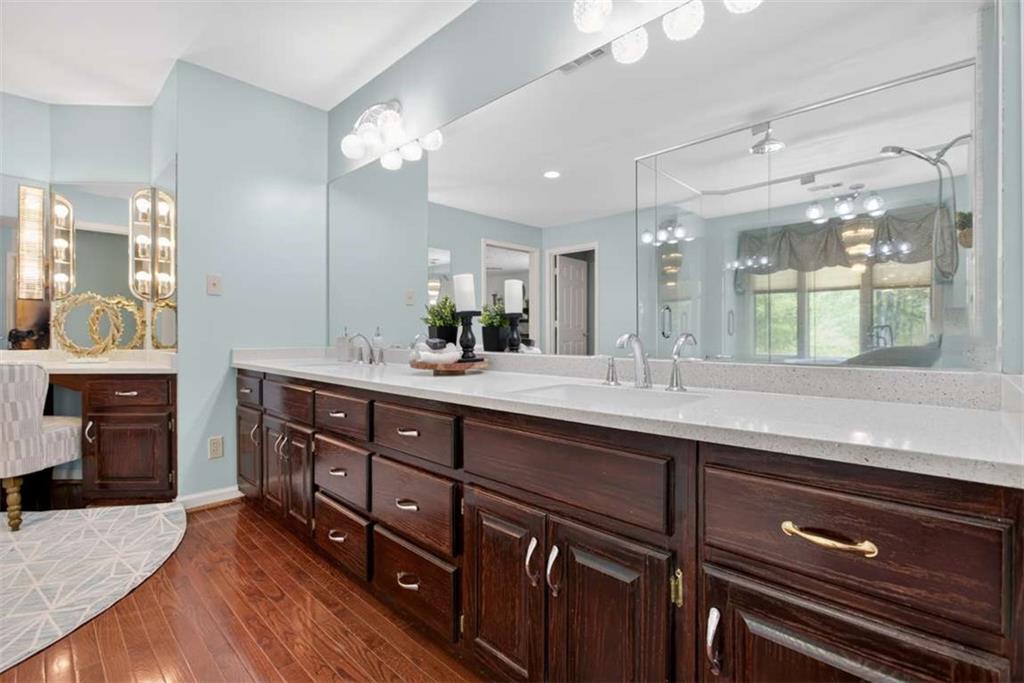 3035 Mt Zion Road Oxford, GA 30054 - Photo 59 of 99 a spacious bathroom with a granite countertop sink a toilet a mirror and shower