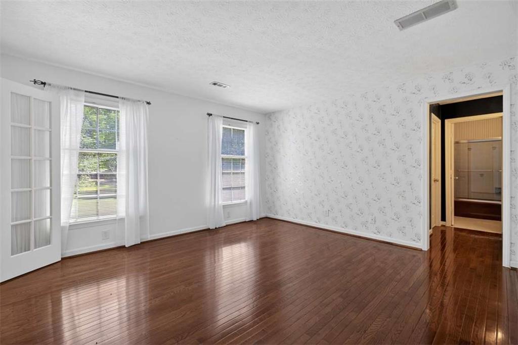 3035 Mt Zion Road Oxford, GA 30054 - Photo 62 of 99 an empty room with wooden floor and windows