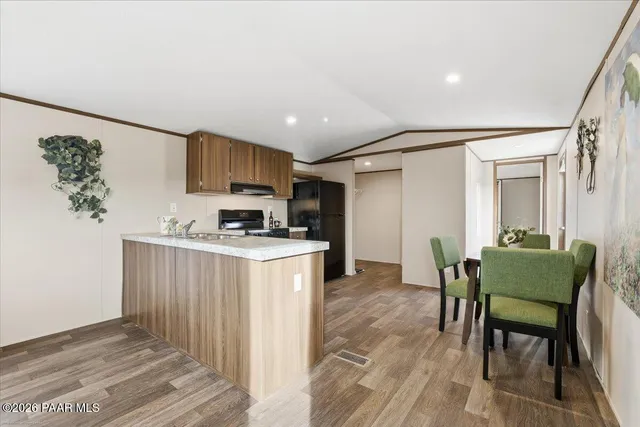 a kitchen with granite countertop furniture and a refrigerator