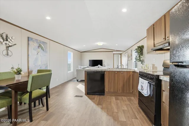 a view of kitchen with furniture and wooden floor
