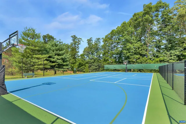 a tennis court with trees in the background