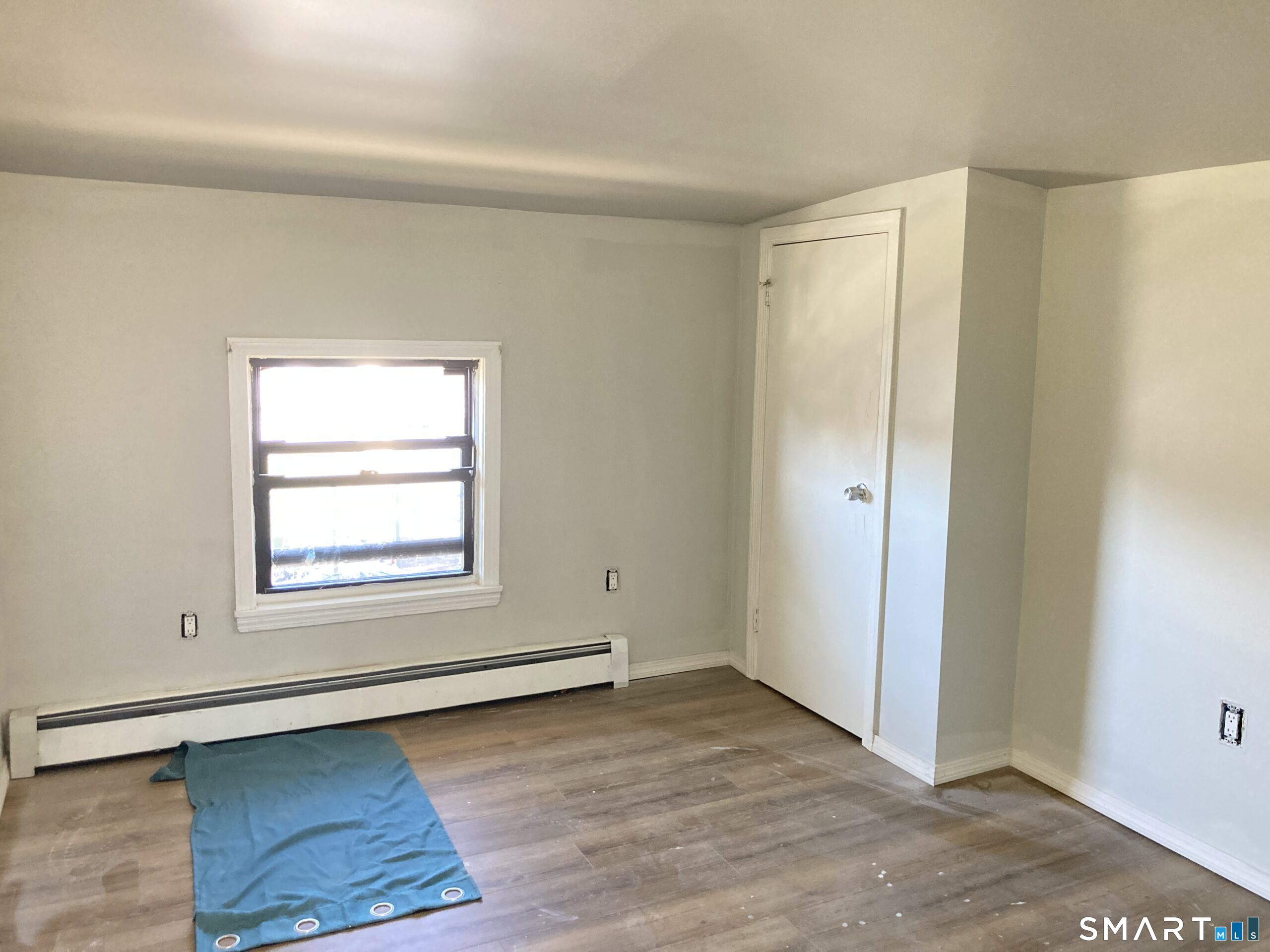 166 Affleck Street Hartford, CT 06106 - Photo 14 of 21 an empty room with wooden floor and windows