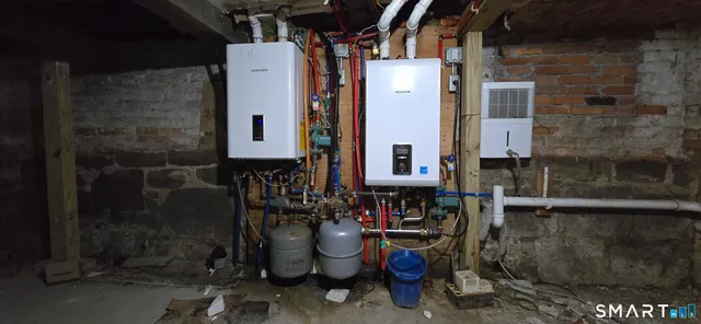 a view of a brick house with many windows and a table