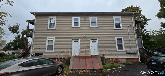 a view of a house with a yard and furniture