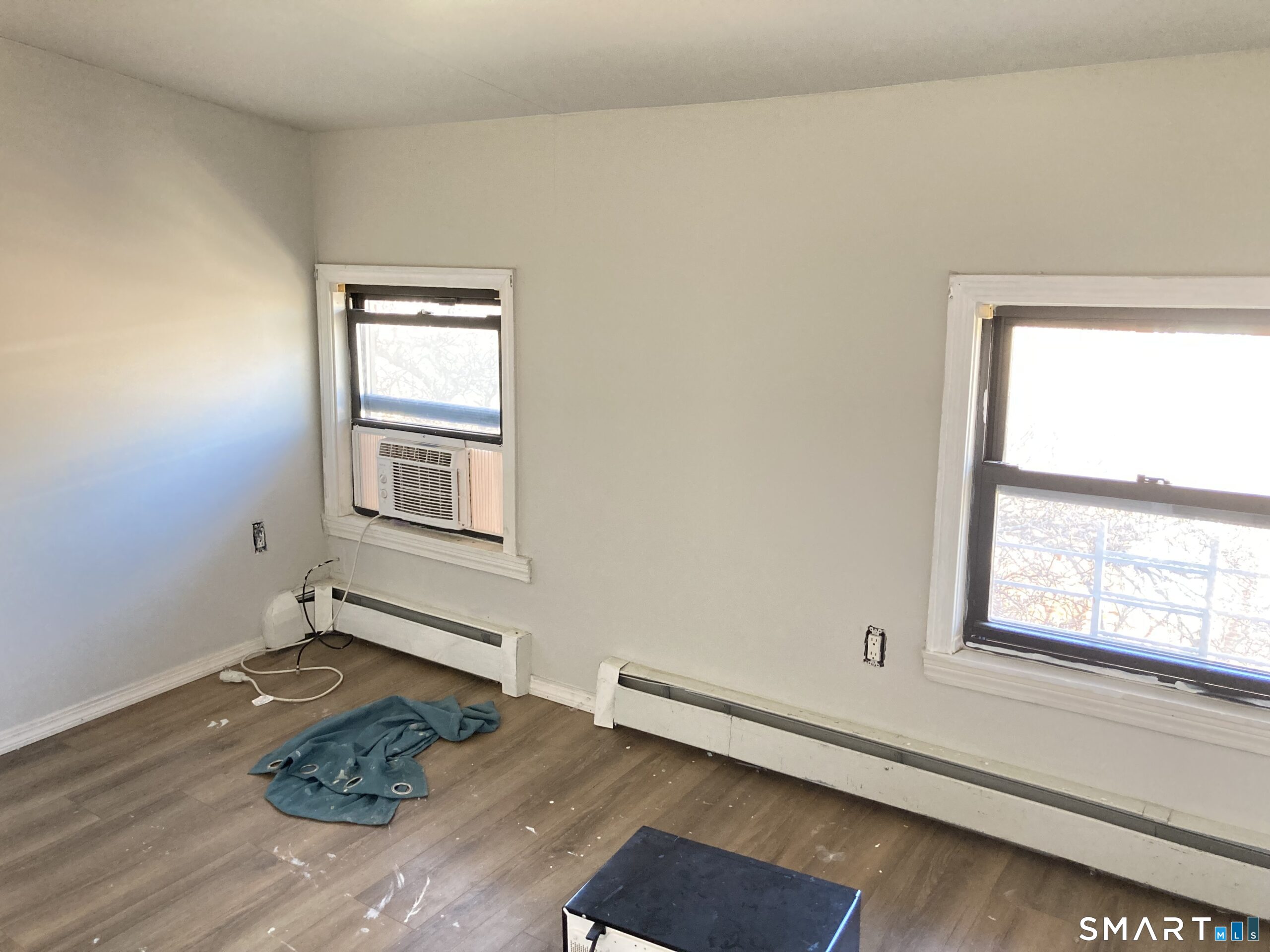 166 Affleck Street Hartford, CT 06106 - Photo 5 of 21 an empty room with wooden floor and windows