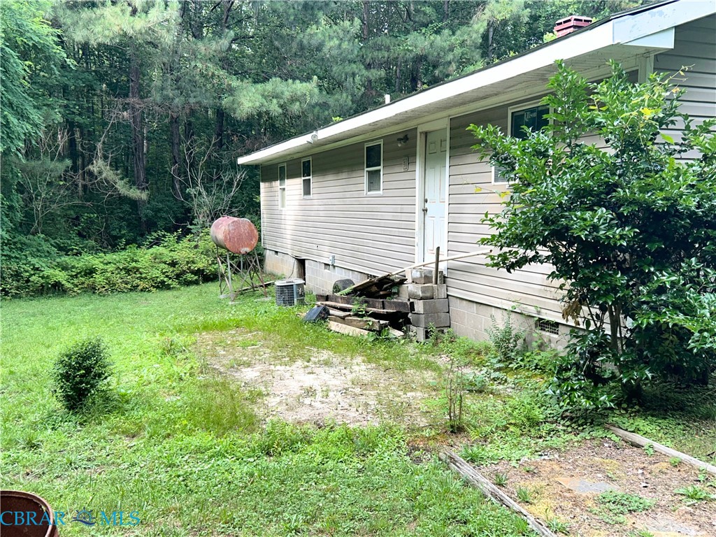 449 Gaskins Road Weems, VA 22576 - Photo 10 of 10 a backyard of a house with table and chairs