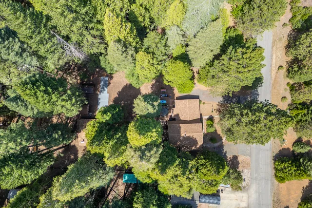 an aerial view of a house with a yard and garden