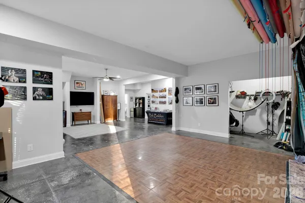 a living room with furniture and paintings on the wall