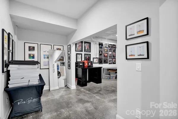 a work room with furniture a bookshelf and a window
