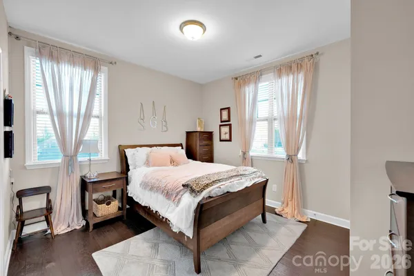 a en suite bathroom with a granite countertop sink and a mirror