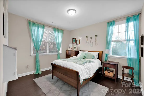 a spacious bedroom with a bed and a window
