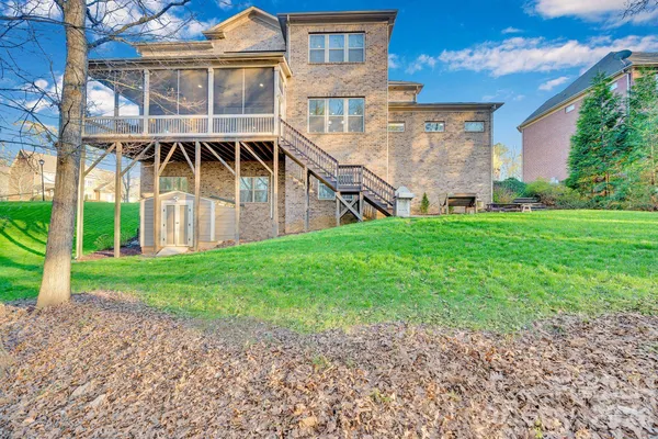 a view of backyard with tall trees