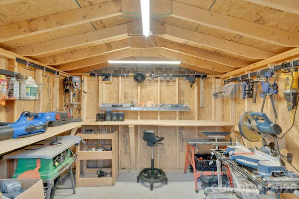 an aerial view of a house with garden space and trees