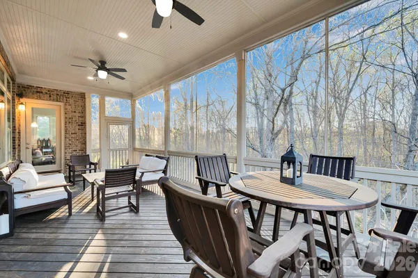 a dining room with furniture a chandelier and wooden floor