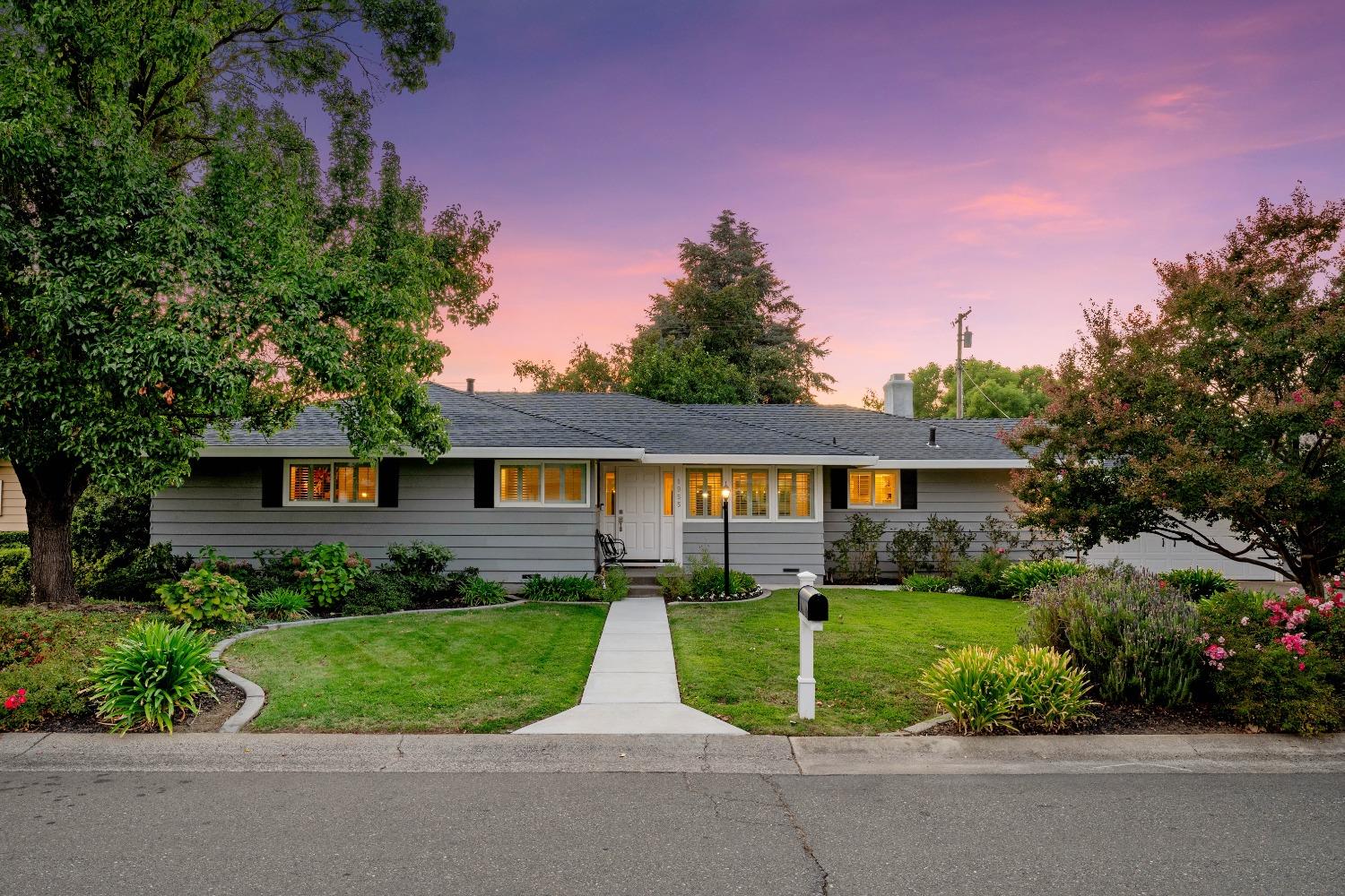 a view of a house with a yard and plants