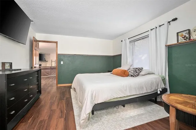 a bedroom with a bed and a dresser