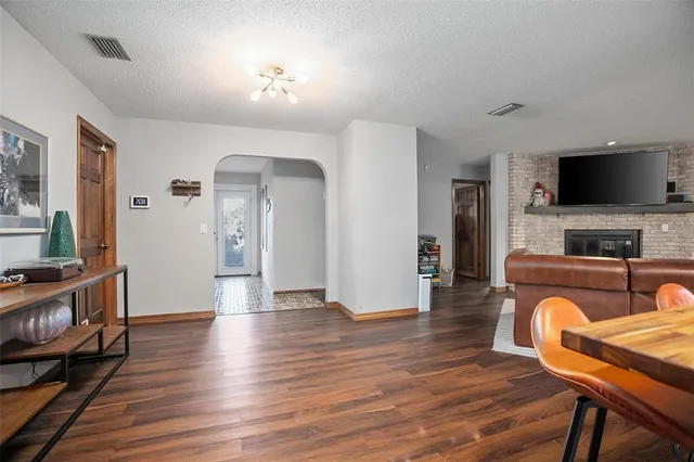 a view of livingroom with furniture flat screen tv and wooden floor