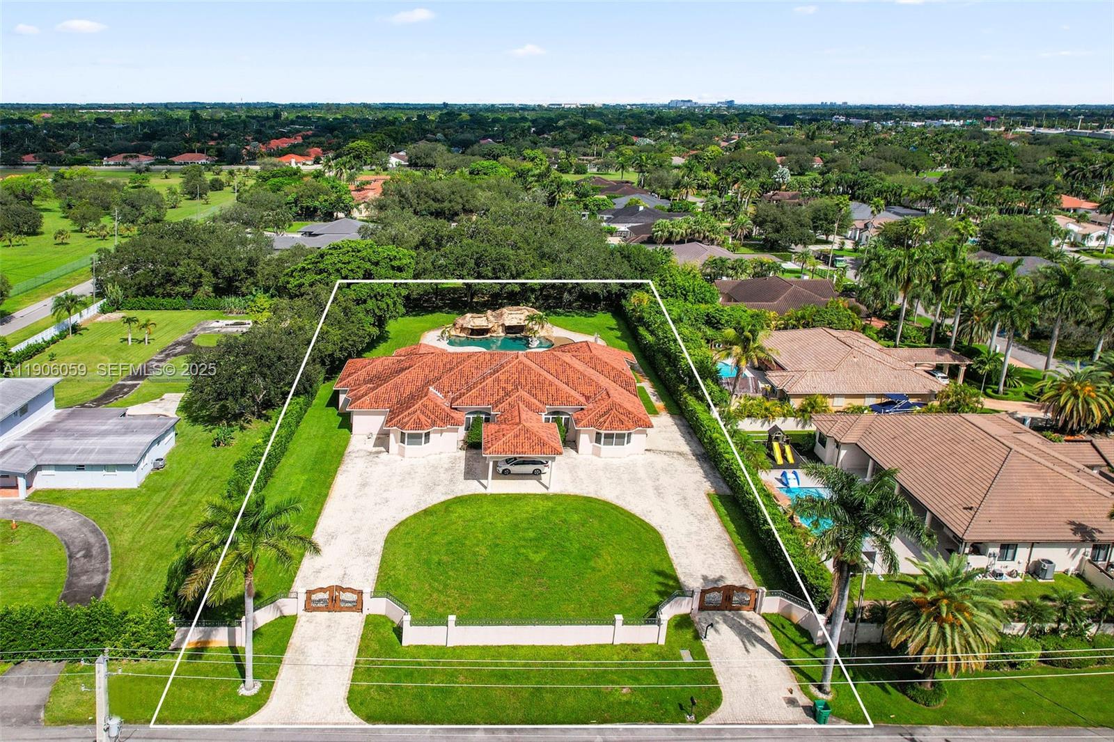 an aerial view of residential houses with outdoor space and trees