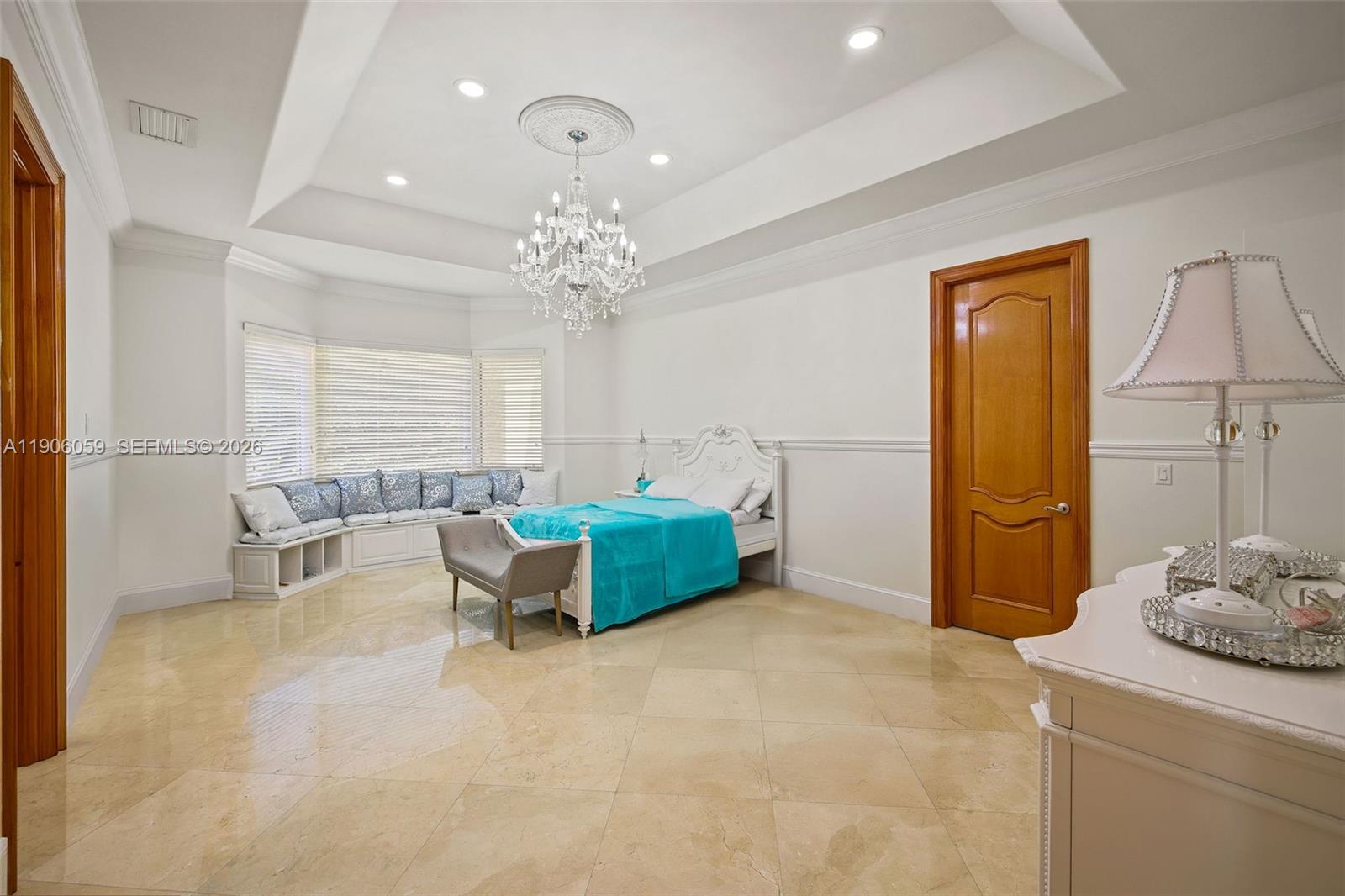 12175 Southwest 80th Street Miami, FL 33183 - Photo 12 of 56 a living room with furniture and a chandelier
