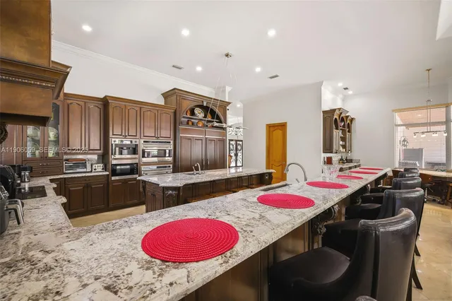 a very nice looking dining room with a large window and furniture