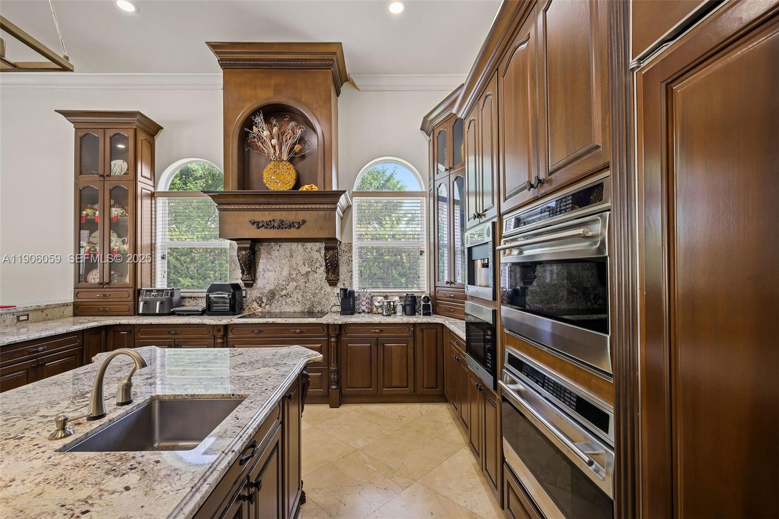 12175 Southwest 80th Street Miami, FL 33183 - Photo 18 of 61 a kitchen with a sink a stove and oven