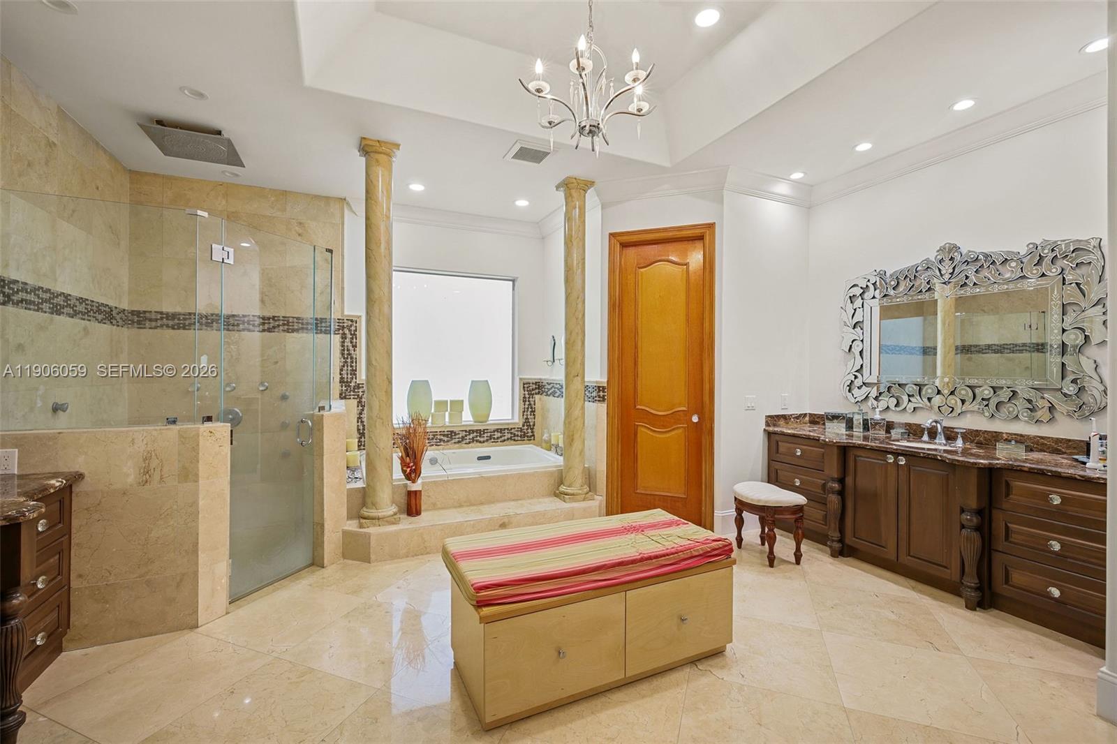 12175 Southwest 80th Street Miami, FL 33183 - Photo 19 of 56 a spacious bathroom with a double vanity sink a large mirror and a bathtub