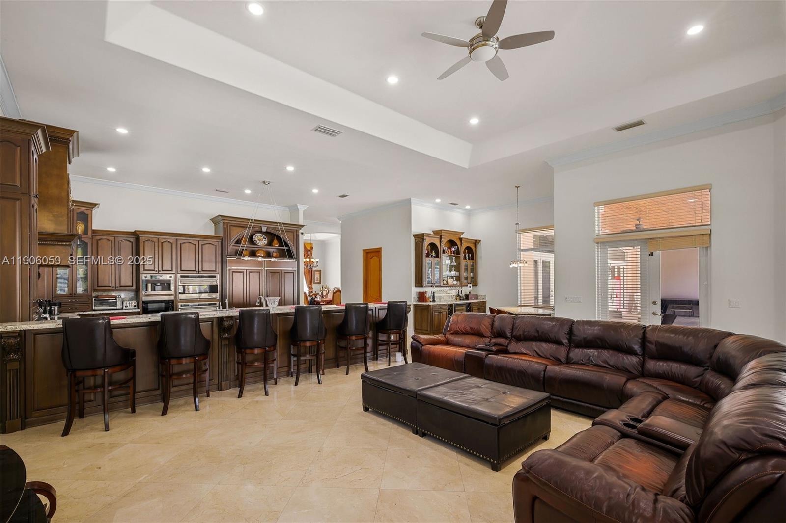 12175 Southwest 80th Street Miami, FL 33183 - Photo 19 of 61 a living room with lots of furniture and kitchen