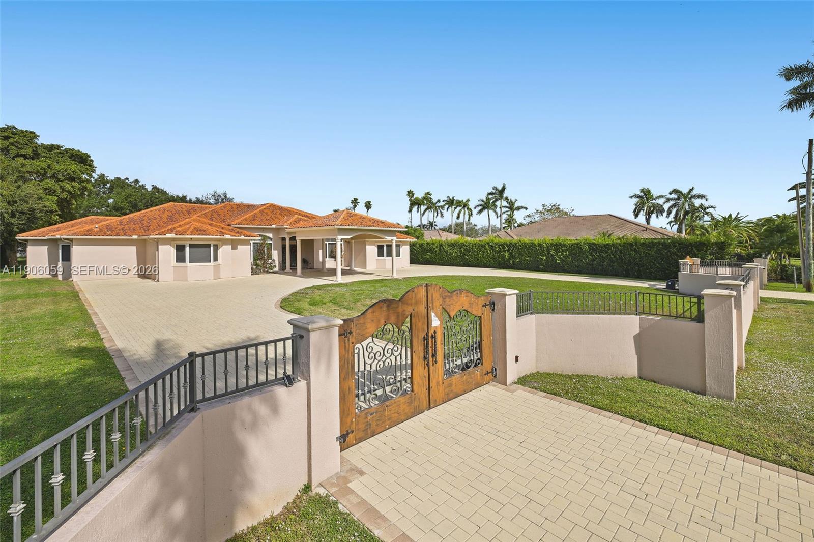12175 Southwest 80th Street Miami, FL 33183 - Photo 2 of 56 a view of a house with wooden floor and a yard