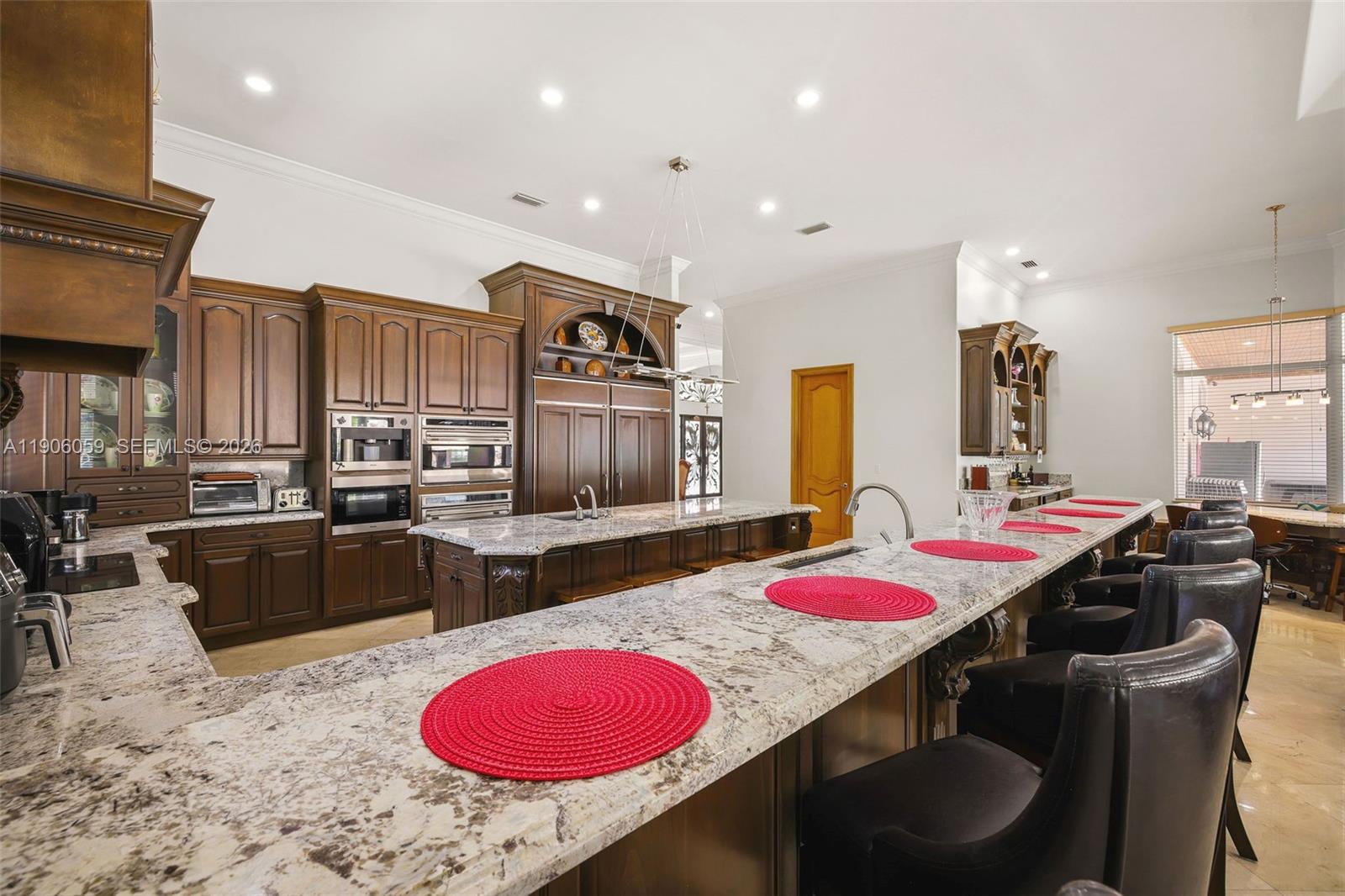 12175 Southwest 80th Street Miami, FL 33183 - Photo 26 of 56 a kitchen with a sink stove and chairs