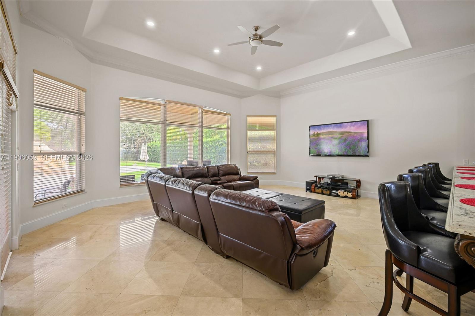 12175 Southwest 80th Street Miami, FL 33183 - Photo 27 of 56 a living room with furniture and large windows